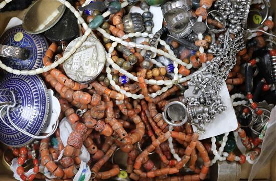 A group of assorted coral necklaces and other ethnic jewellery.